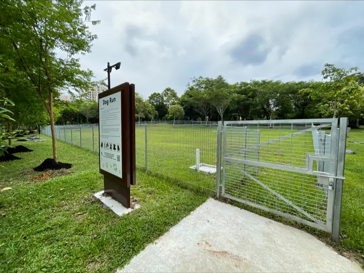 The entrance gate and fenced grass area at Punggol Waterway Park Dog Run.