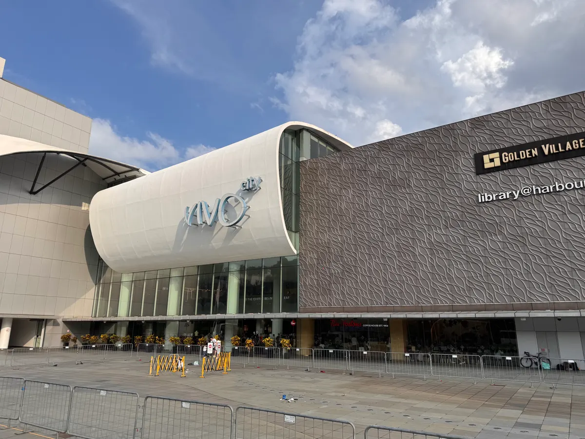 The curved exterior facade and VivoCity sign at HarbourFront, Singapore.